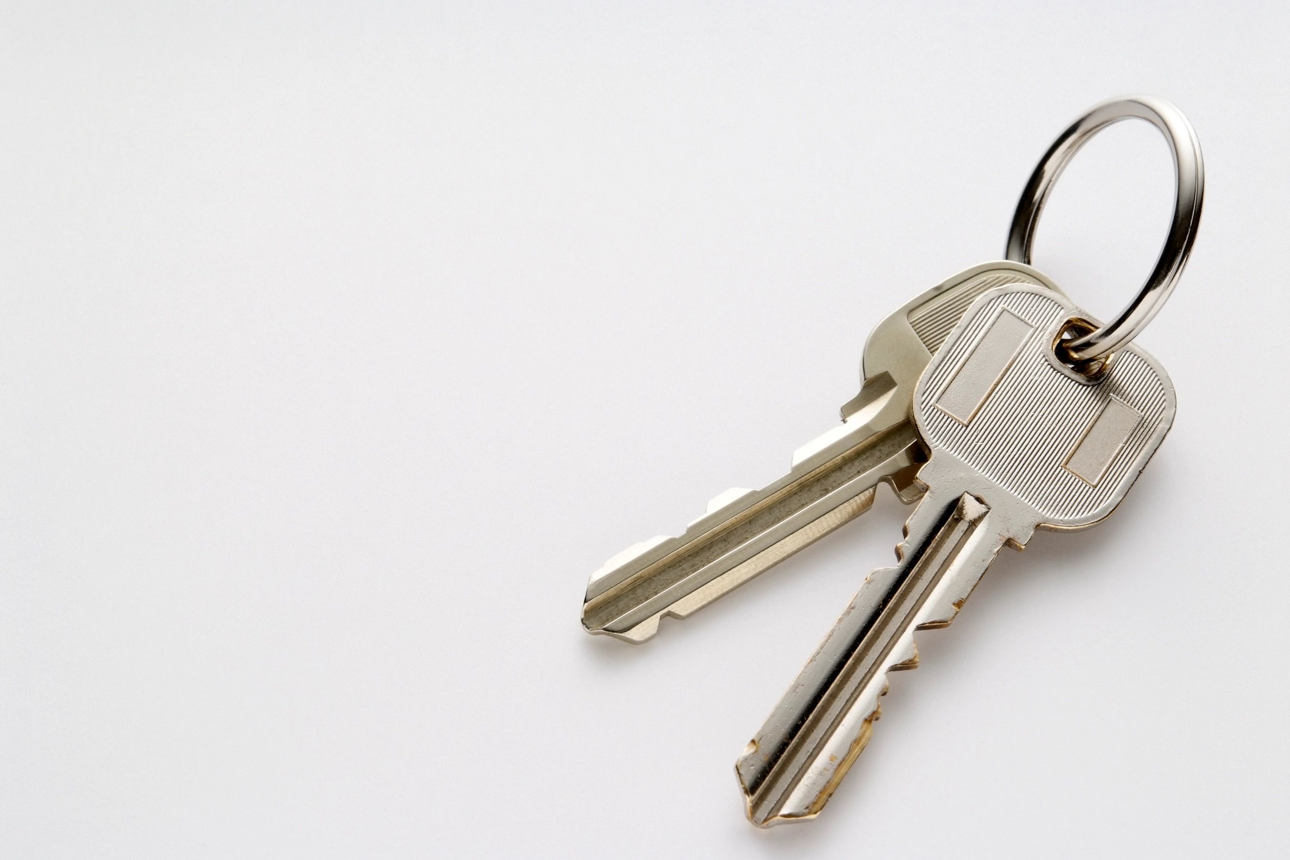 Two cut keys on a white background